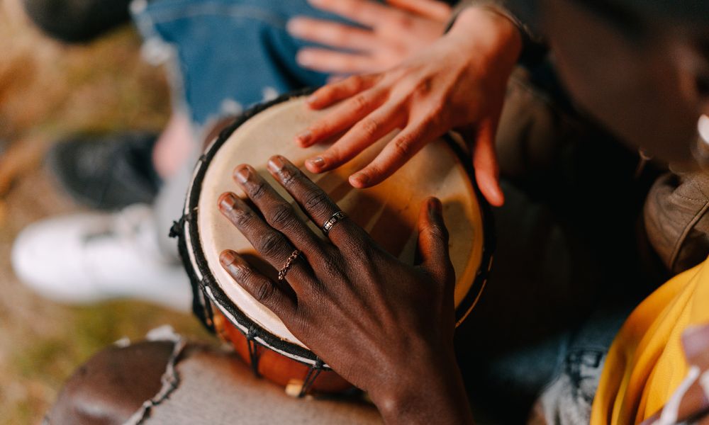 Hands playing a traditional African drum from a top-down view during the 6 Day Bush and Beyond safari with Nhongo Safaris in South Africa.