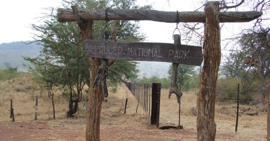 Rustic wooden entrance sign welcoming visitors to Kruger National Park